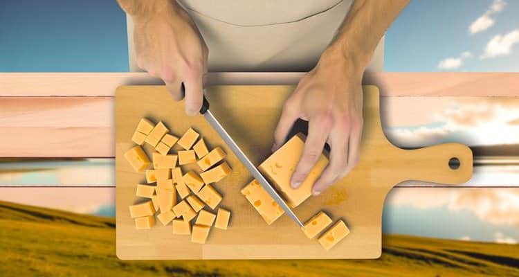 Overhead view of cutting cheddar cheese into blocks for cold smoking Overhead view of cutting cheddar cheese into blocks for cold smoking