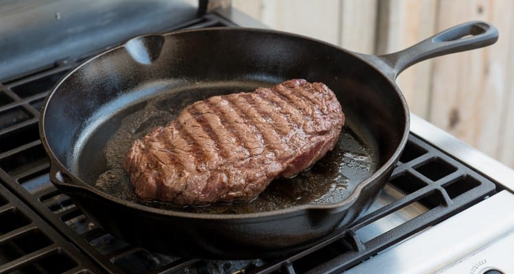 Reverse searing smoked flank steak Smoked flank steak searing in a cast iron skillet