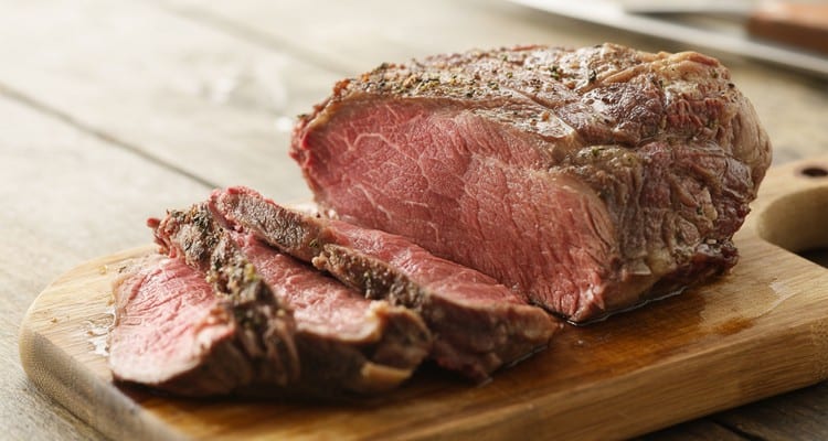 Beef Chuck Steak Recipe — Grilled, Smoked, or Braised to Perfection Sliced beef chuck steak on a rustic wooden cutting board showing a juicy medium-rare interior